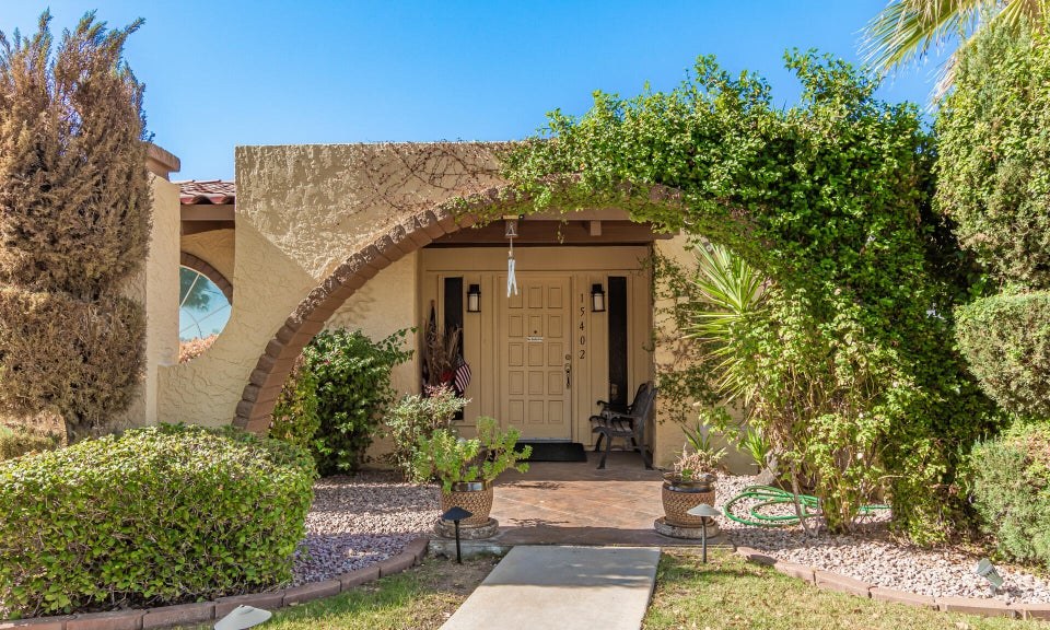Arched, vine-covered front entry of Theresa Loving Care Home