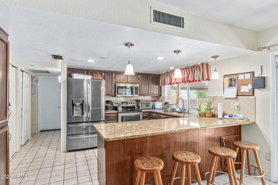 Kitchen with granite counter and breakfast bar